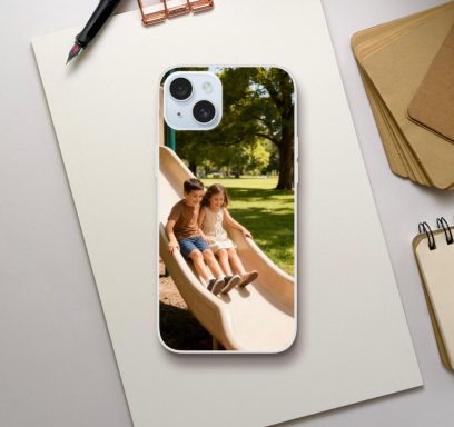 Two children sliding down a playground slide in a sunny park setting.